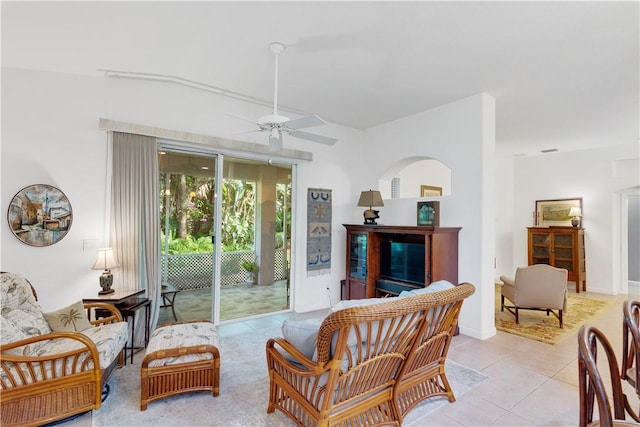living area with ceiling fan and light tile patterned floors