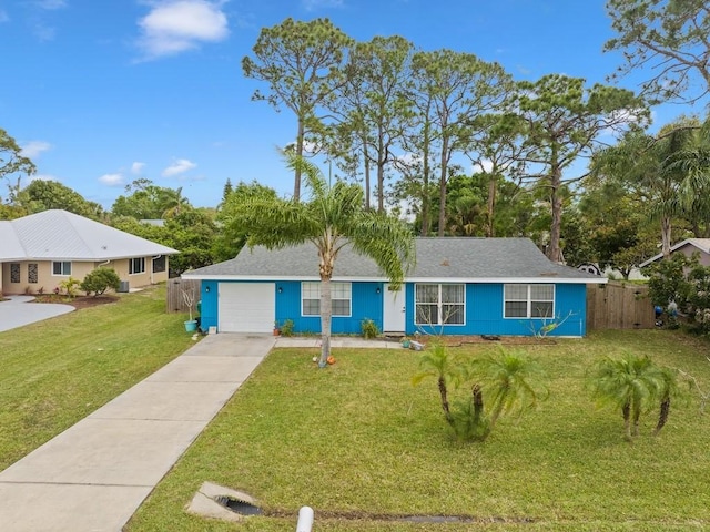 ranch-style house featuring a garage, driveway, a front yard, and fence