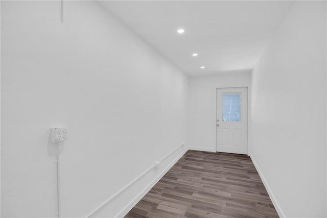 interior space with baseboards, wood finished floors, and recessed lighting