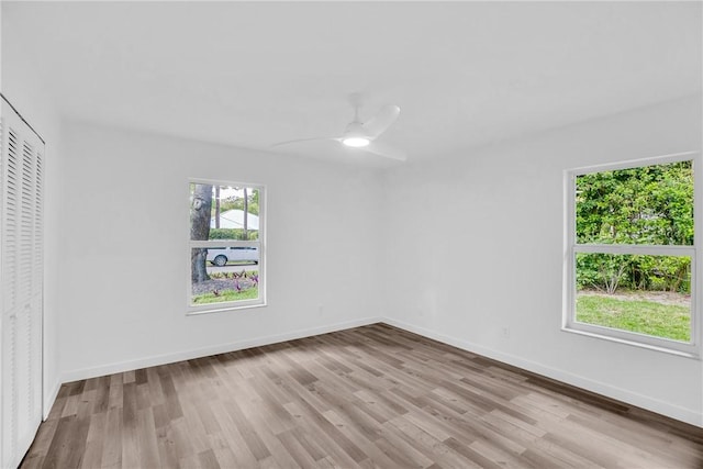 unfurnished bedroom with a ceiling fan, a closet, baseboards, and wood finished floors