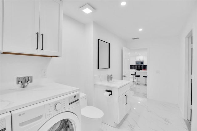 bathroom with marble finish floor, recessed lighting, toilet, vanity, and washer / dryer