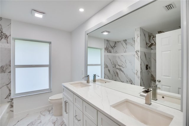 full bathroom featuring marble finish floor, a sink, and a marble finish shower