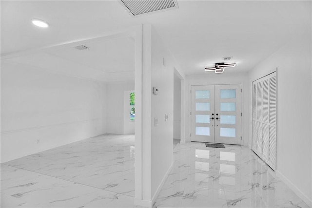 foyer with marble finish floor, visible vents, baseboards, and french doors