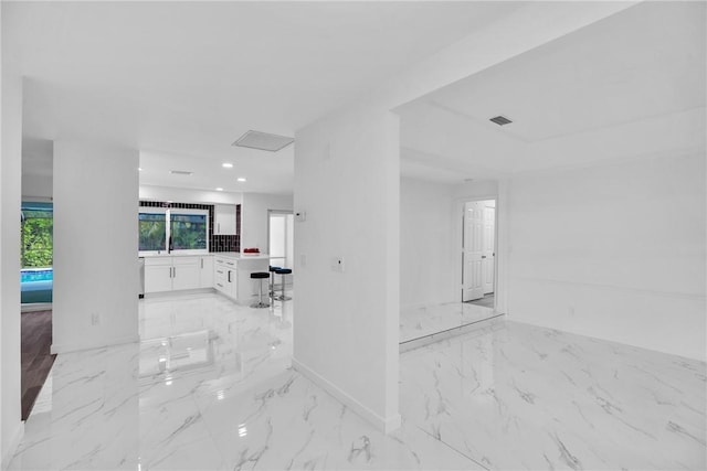 interior space featuring marble finish floor, baseboards, visible vents, and recessed lighting