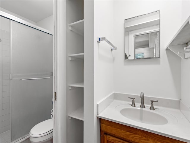 bathroom featuring vanity, toilet, and walk in shower