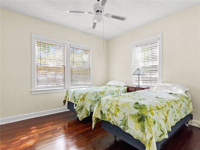 bedroom with dark hardwood / wood-style flooring, multiple windows, and ceiling fan