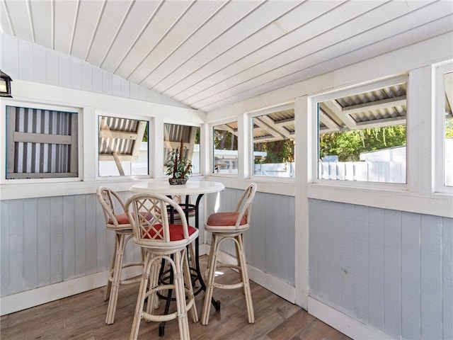 sunroom / solarium with wood ceiling and lofted ceiling