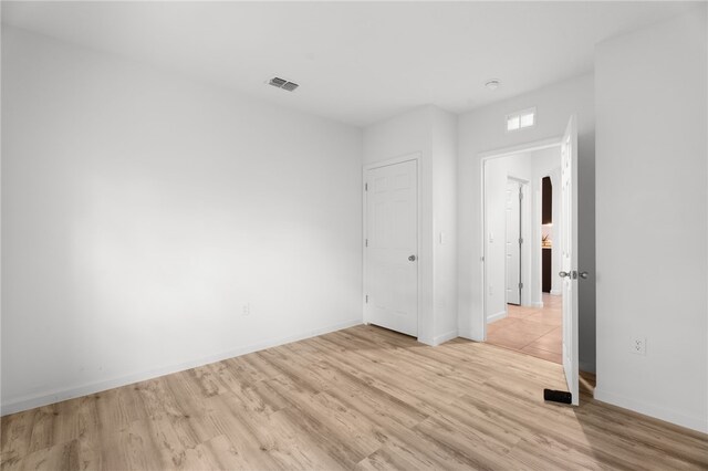 1093 Wabash Rd SE, Palm Bay, FL 32909 - unfurnished bedroom featuring light wood-style flooring