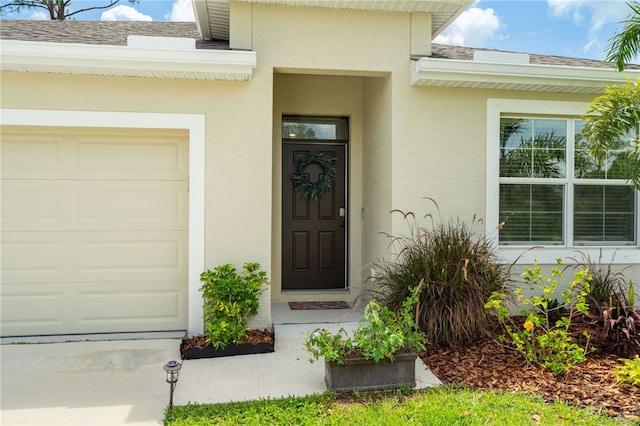 1093 Wabash Rd SE, Palm Bay, FL 32909 - entrance to property featuring a garage, stucco siding, and a shingled roof