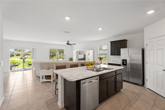 1093 Wabash Rd SE, Palm Bay, FL 32909 - kitchen featuring appliances with stainless steel finishes, a sink, light countertops, plenty of natural light, and recessed lighting