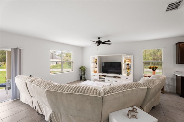1093 Wabash Rd SE, Palm Bay, FL 32909 - tiled living area with healthy amount of natural light and a ceiling fan