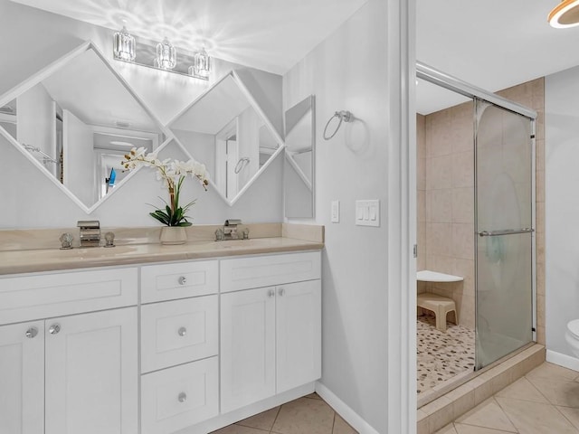 bathroom with vanity, an enclosed shower, and tile patterned floors