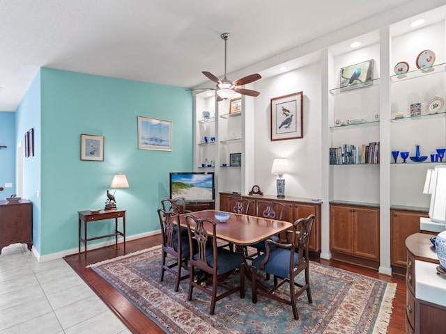 dining space with light hardwood / wood-style floors, ceiling fan, and built in features