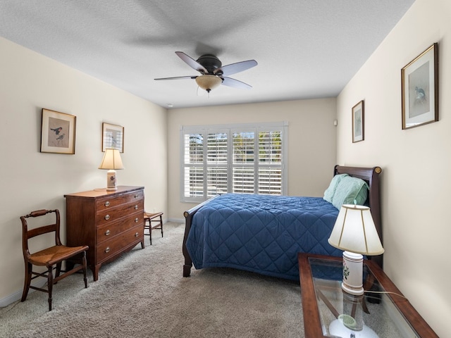 carpeted bedroom with a textured ceiling and ceiling fan