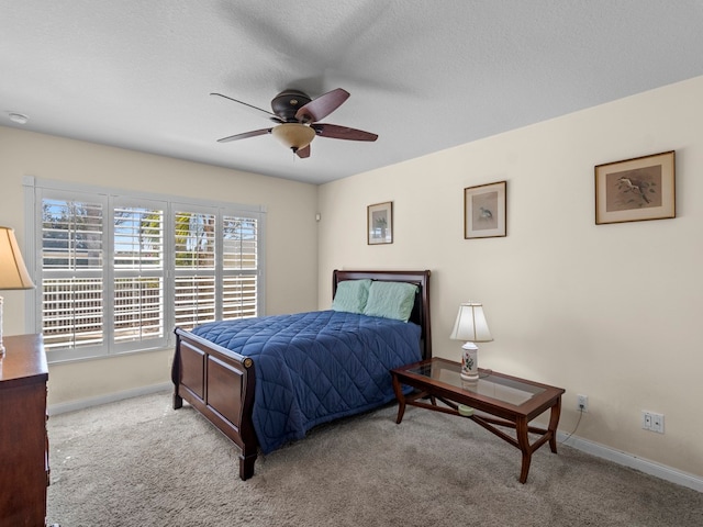 carpeted bedroom with a textured ceiling and ceiling fan