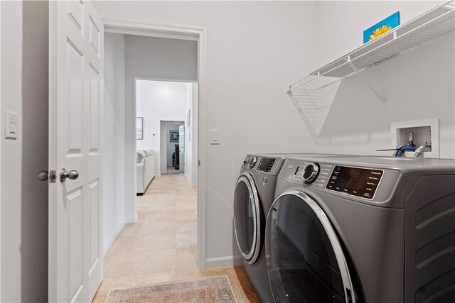 1440 Carriage Ct, Vero Beach, FL 32966 - laundry room with independent washer and dryer, light tile patterned flooring, and baseboards