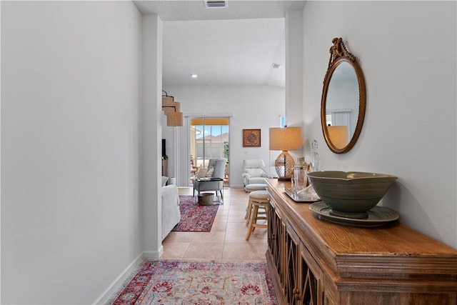 1440 Carriage Ct, Vero Beach, FL 32966 - hall featuring light tile patterned floors, baseboards, and lofted ceiling
