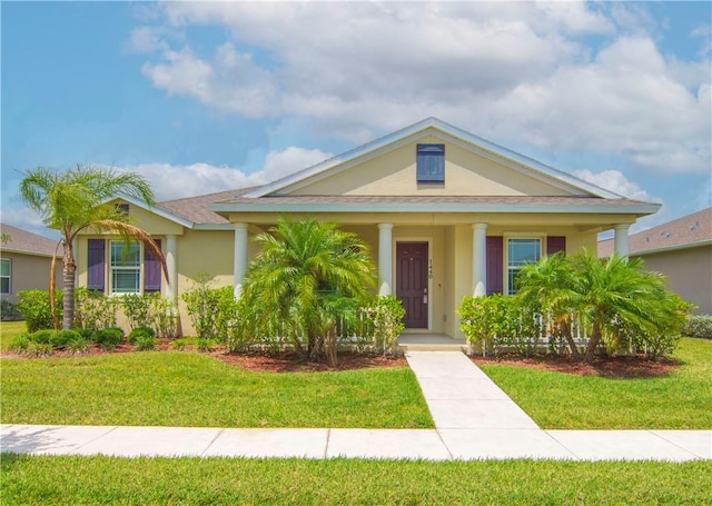 1440 Carriage Ct, Vero Beach, FL 32966 - view of front of house featuring a front lawn, stucco siding, and a porch