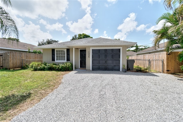 single story home with a garage and a front lawn