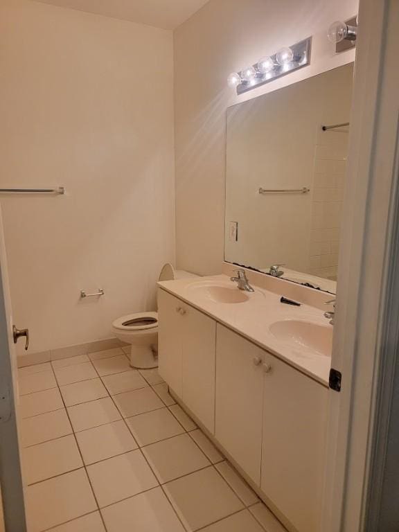 full bathroom with tile patterned floors, toilet, double vanity, and baseboards