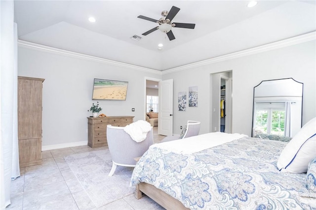 tiled bedroom with a tray ceiling, ceiling fan, and crown molding