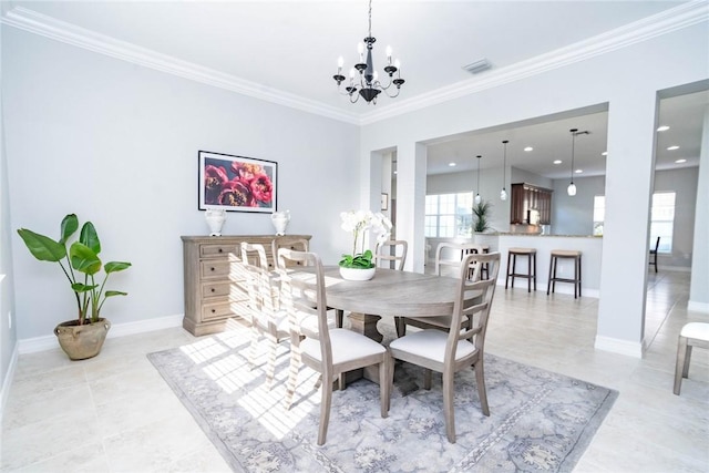 tiled dining room featuring ornamental molding and a notable chandelier