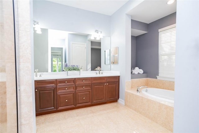 bathroom with tile patterned floors, vanity, and a relaxing tiled tub