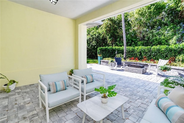 view of patio / terrace featuring an outdoor living space with a fire pit