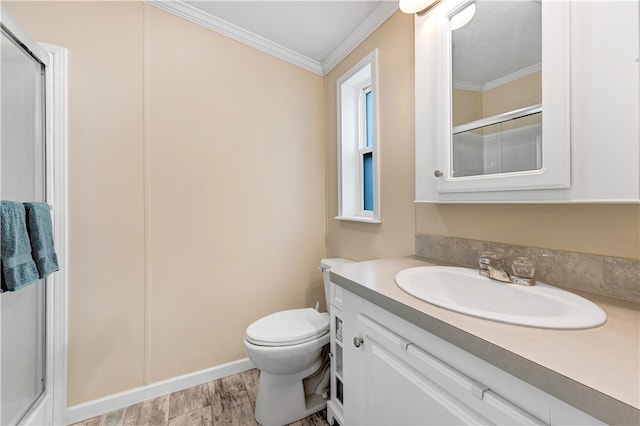 bathroom with ornamental molding, vanity, hardwood / wood-style floors, toilet, and a shower with shower door