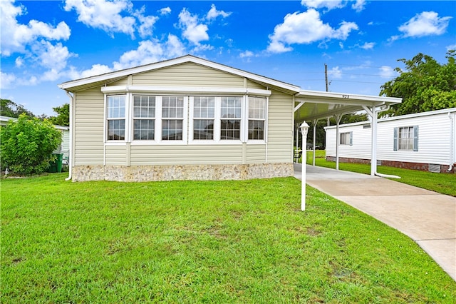 view of front of home with a front lawn and a carport