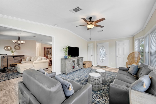 living room featuring ornamental molding, light wood-type flooring, and lofted ceiling