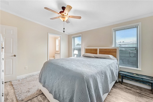 bedroom with ensuite bathroom, light hardwood / wood-style flooring, ornamental molding, and ceiling fan