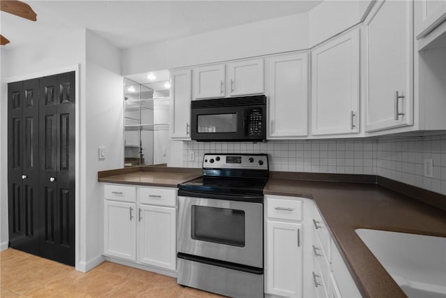 kitchen featuring stainless steel electric stove, white cabinetry, backsplash, and light tile patterned floors