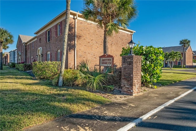 view of property exterior with a lawn