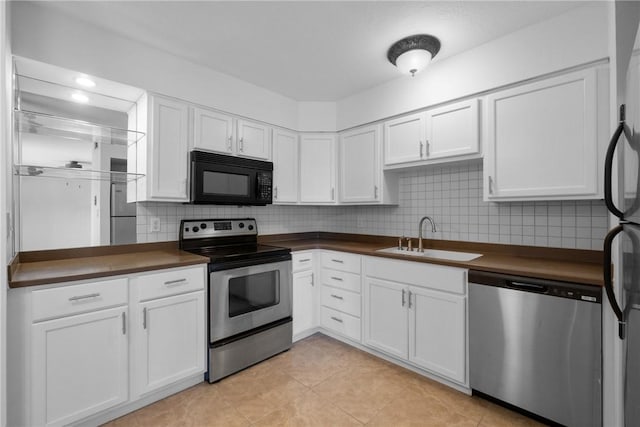 kitchen featuring white cabinets, stainless steel appliances, and sink