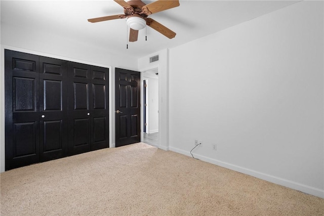 unfurnished bedroom with ceiling fan and carpet floors