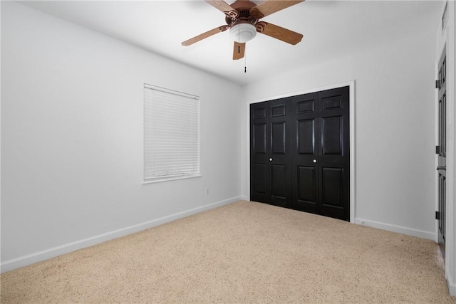 unfurnished bedroom with ceiling fan, a closet, and light carpet