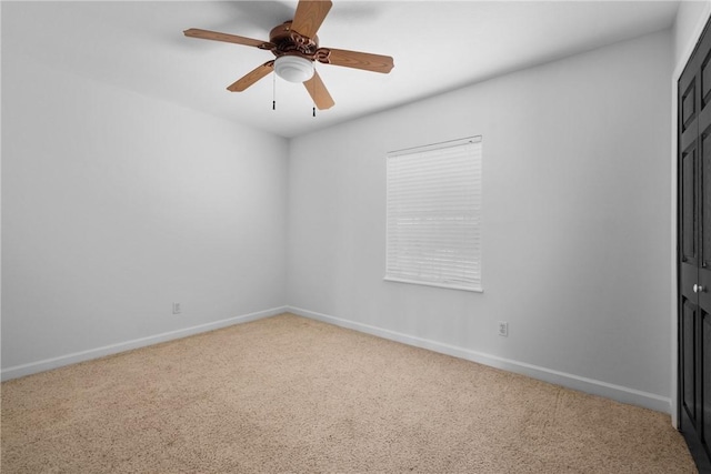 empty room featuring carpet flooring and ceiling fan