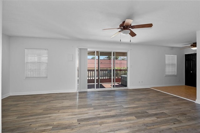 spare room featuring dark hardwood / wood-style floors and ceiling fan