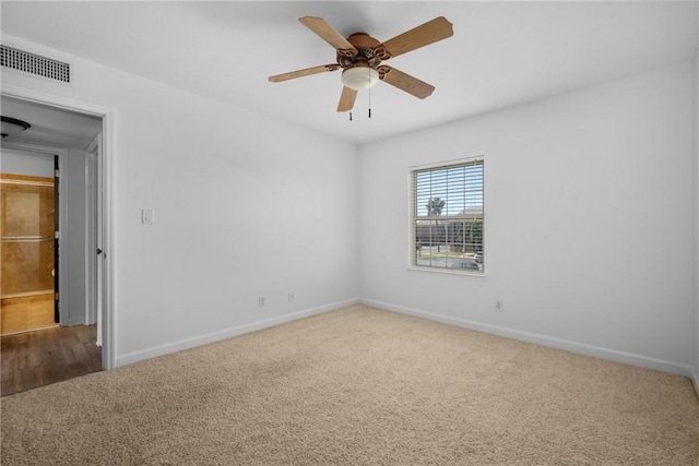 spare room featuring carpet and ceiling fan