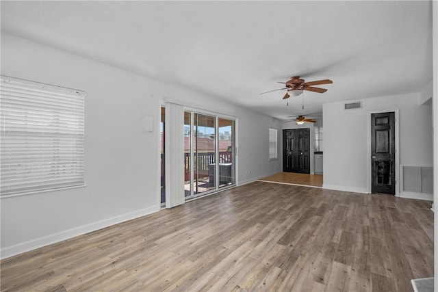 unfurnished living room with light wood-type flooring and ceiling fan