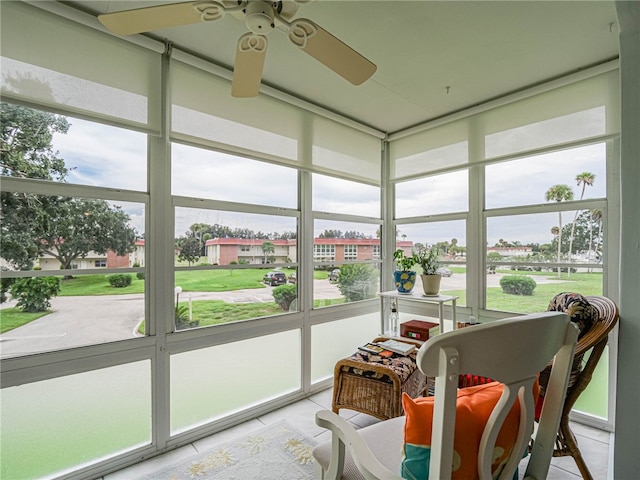 sunroom featuring ceiling fan