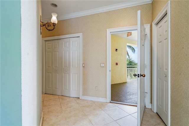 corridor with a chandelier, light tile patterned floors, and ornamental molding