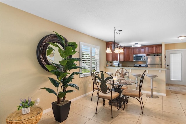 dining area with light tile patterned floors and baseboards