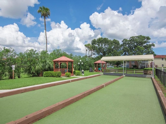 surrounding community with a lawn and a gazebo