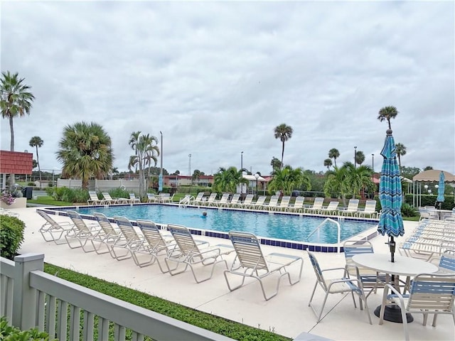 pool featuring a patio area and fence