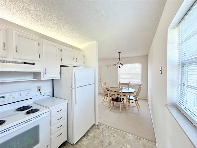 kitchen featuring light countertops, white cabinetry, a textured ceiling, white appliances, and under cabinet range hood