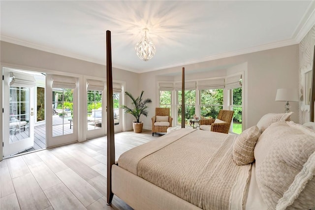 bedroom with ornamental molding, a notable chandelier, access to exterior, and light wood-style floors