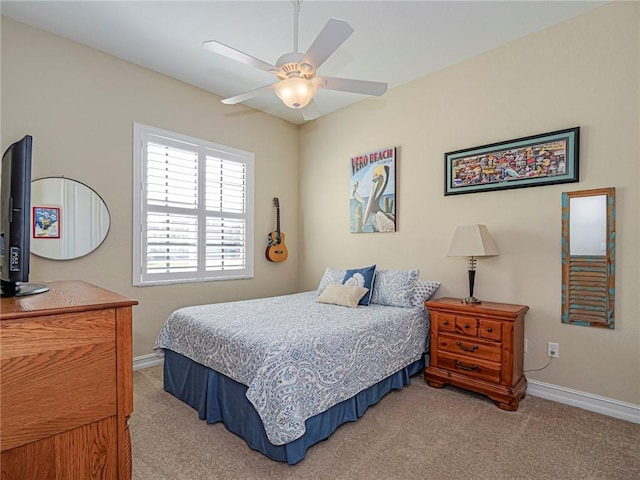 bedroom featuring baseboards, a ceiling fan, and light colored carpet