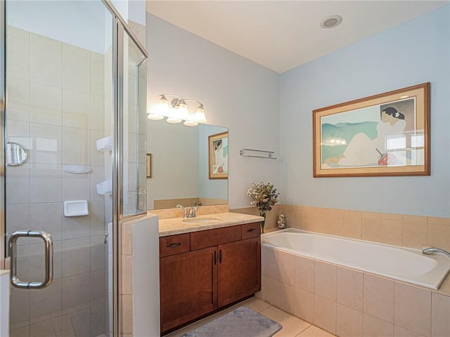 bathroom featuring tile patterned floors, vanity, a shower stall, and a bath